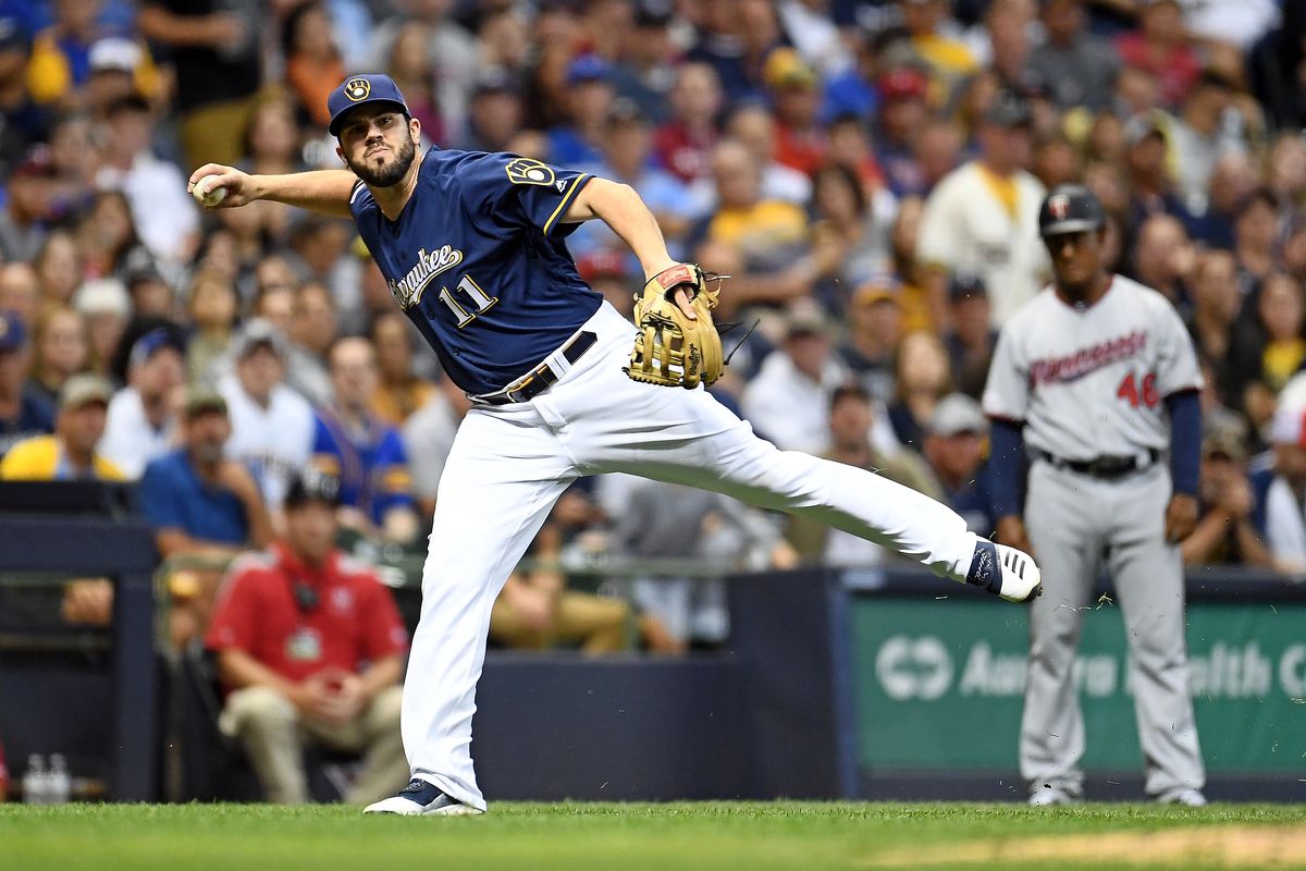 Mike Moustakas #11 of the Milwaukee Brewers makes a throw to first base during a game against the Minnesota Twins at Miller Park on August 13, 2019 in Milwaukee, Wisconsin.