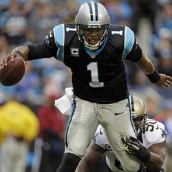Carolina Panthers' Cam Newton (1) is sacked by New Orleans Saints' Curtis Lofton (50) in the first half of an NFL football game in Charlotte, N.C., Sunday, Dec. 22, 2013. 