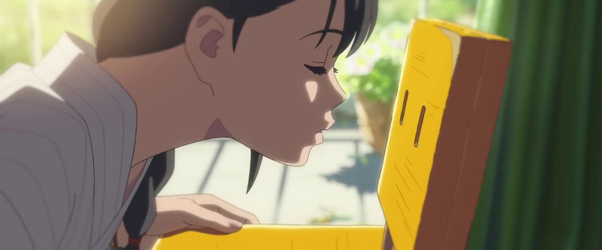 A close-up shot of an anime girl leaning in to kiss a wooden chair.