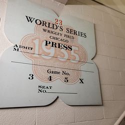 Replica of old World Series press pin, on stairs up to press box