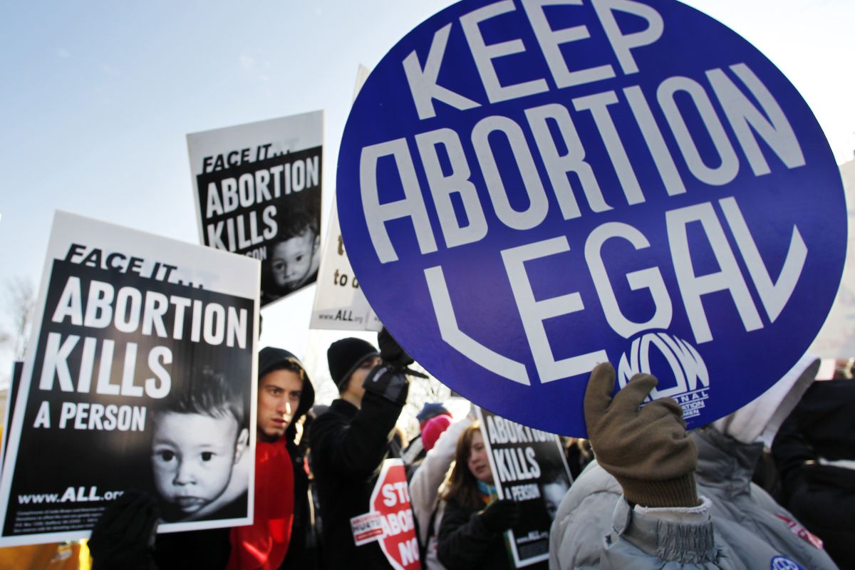 Anti-abortion and abortion activists stand side by side in front of the U.S. Supreme Court, in Washington, Monday, Jan. 24, 2011, during a rally against Roe v. Wade on the anniversary of the U.S. Supreme Court decision. (AP Photo/Manuel Balce Ceneta)
