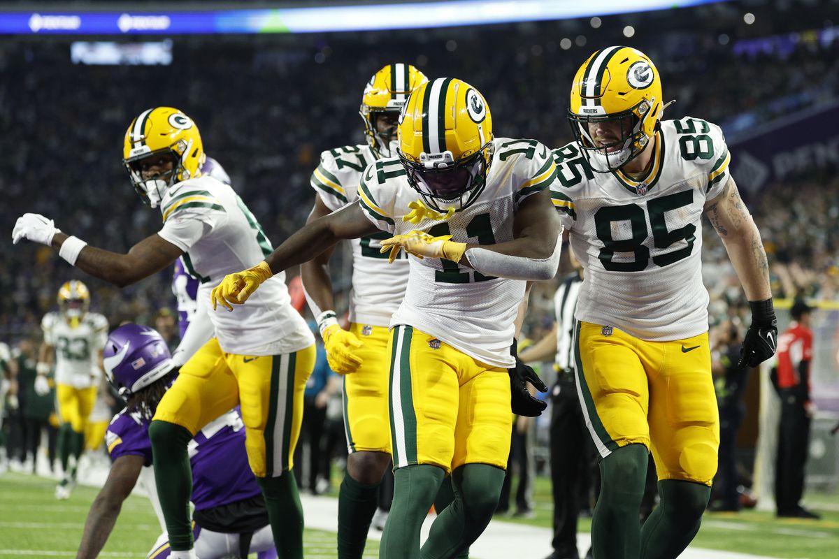 Jayden Reed #11 of the Green Bay Packers celebrates after a touchdown during the second quarter against the Minnesota Vikings at U.S. Bank Stadium on December 31, 2023 in Minneapolis, Minnesota.