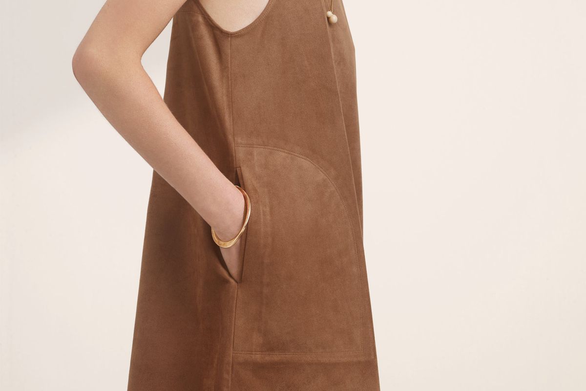 A model wearing a brown suede dress with pockets