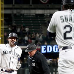 AJ Pollock #8 of the Seattle Mariners celebrates his two run home run with Eugenio Suarez #28 during the fifth inning against the Los Angeles Angels at T-Mobile Park on April 04, 2023 in Seattle, Washington.