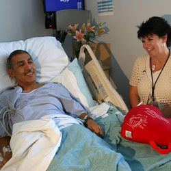Carl Gallegos and nurse Lori Bertelsen laugh during a visit at the hospital in Provo on Friday, June 21, 2013. Bertelsen performed CPR on Gallegos after he went into cardiac arrest after running a half marathon last week.