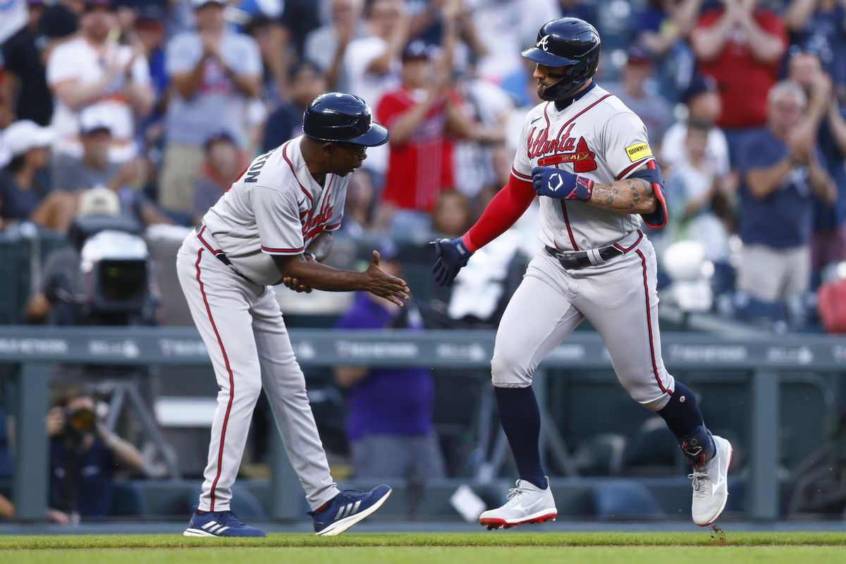 Kevin Pillar of the Atlanta Braves is congratulated on his solo home run by third base coach Ron Washington in the third inning against the Colorado Rockies at Coors Field on August 30, 2023 in Denver, Colorado.
