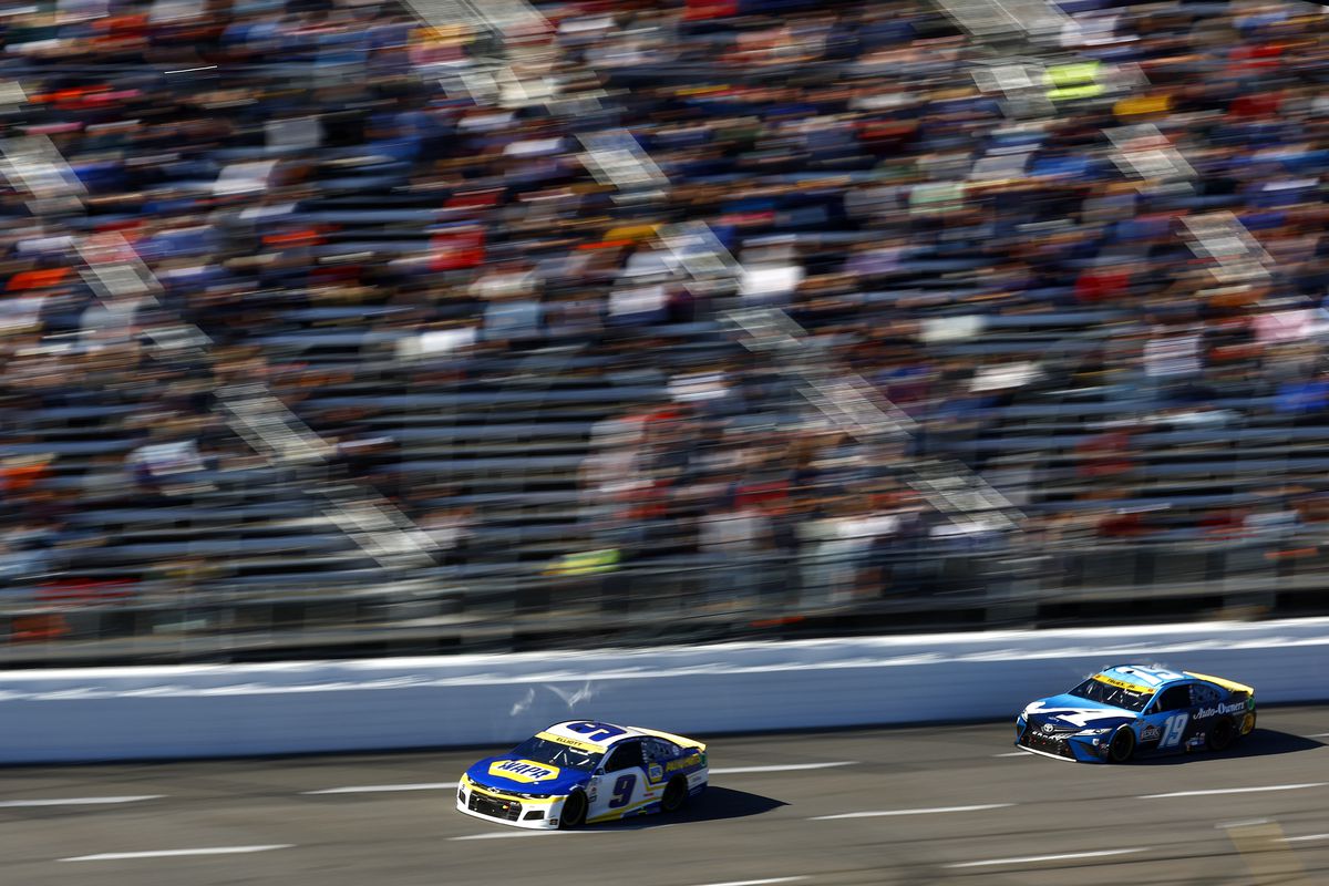 Chase Elliott, driver of the #9 NAPA Auto Parts Chevrolet, and Martin Truex Jr., driver of the #19 Auto-Owners Insurance Toyota,race during the NASCAR Cup Series Xfinity 500 at Martinsville Speedway on October 31, 2021 in Martinsville, Virginia.