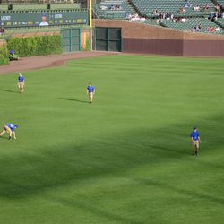 Mon 6:20 p.m. The grounds crew checking the field for trash - 
