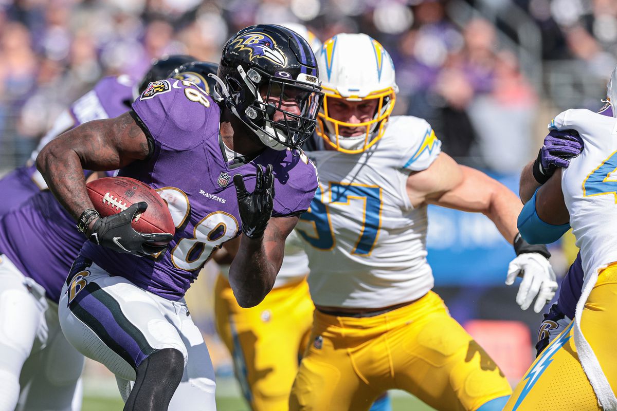 Baltimore Ravens running back Latavius Murray (28) carries the ball as Los Angeles Chargers defensive end Joey Bosa (97) defends during the first half at M&amp;amp;T Bank Stadium.