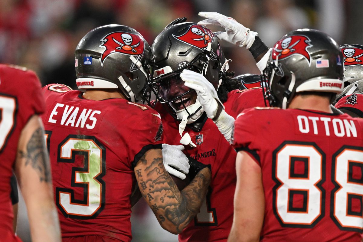 Rachaad White #1 of the Tampa Bay Buccaneers is congratulated by Mike Evans #13 after scoring a rushing touchdown against the Jacksonville Jaguars at Raymond James Stadium on December 24, 2023 in Tampa, Florida.