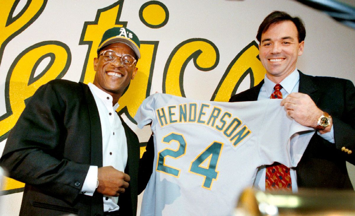 Nick Lammers 1/28/98 Tribune News Rickey Henderson is back for the fourth tour as an Oakland Athletic. He will continue to be wearing his No. 24, which he holds up with General Manager Billy Beane.