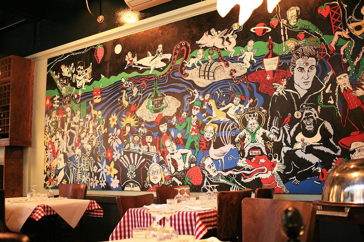 Red-and-white gingham tables are backed by a detailed mural by Neil Fox, depicting skeletons, animals, planets, and surfers.