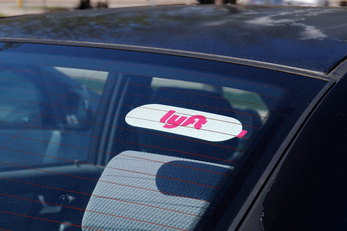 Close-up of car window with a Lyft sticker on it