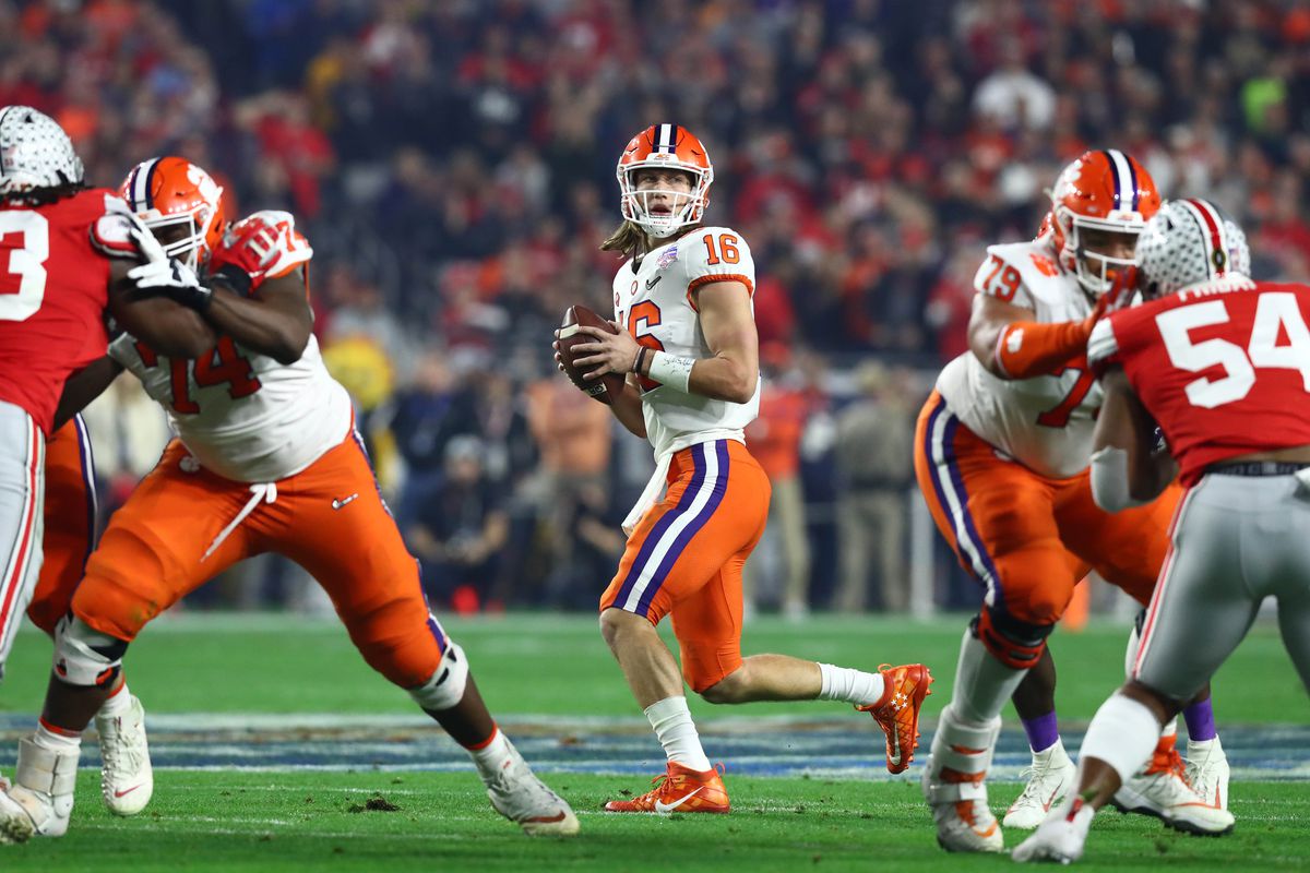 Clemson Tigers quarterback Trevor Lawrence drops back to pass against the Ohio State Buckeyes during the first quarter in the 2019 Fiesta Bowl college football playoff semifinal game at State Farm Stadium.