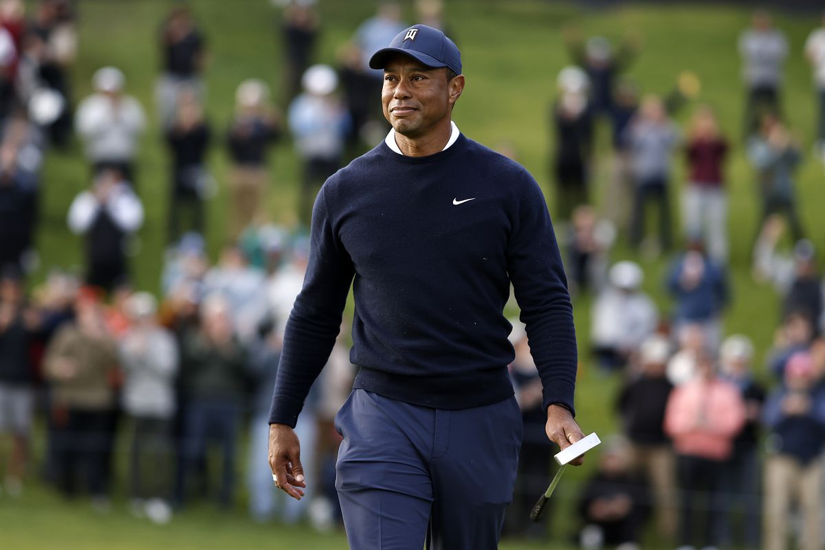Tiger Woods of the United States walks off the 18th green after finishing his round during the first round of the The Genesis Invitational at Riviera Country Club on February 16, 2023 in Pacific Palisades, California.