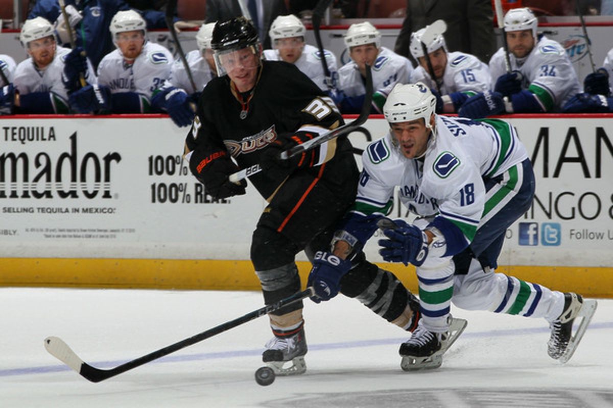 ANAHEIM CA - OCTOBER 13:  Jason Blake #33 of the Anaheim Ducks chases after the puck with Peter Schaefer #18 of the Vancouver Canucks during their game at Honda Center on October 13 2010 in Anaheim California.  (Photo by Jeff Gross/Getty Images)