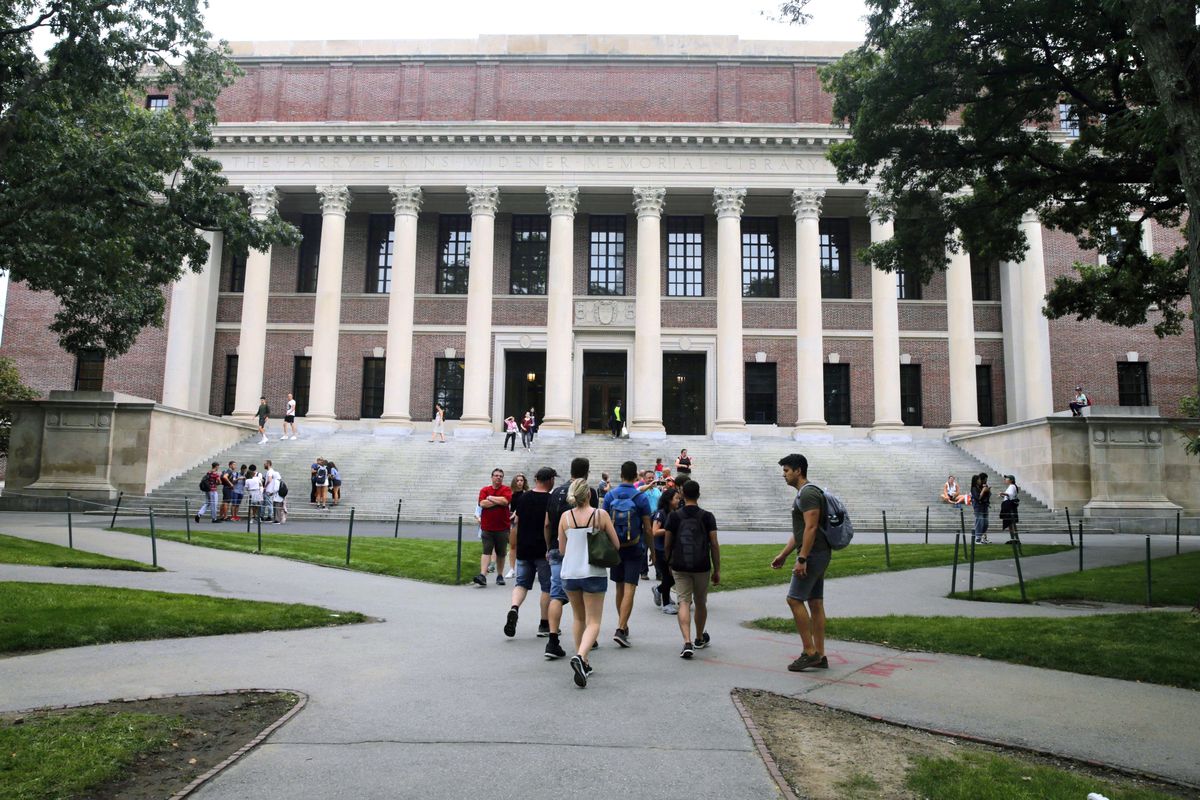 In this Aug. 13, 2019 file photo, students walk near the Widener Library at Harvard University in Cambridge, Mass. A federal appeals court on Thursday upheld a district court decision clearing Harvard University of intentional discrimination against Asian American applicants. 