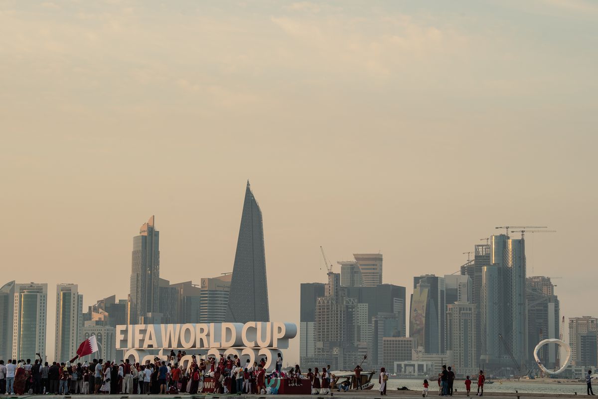 Members of the Ladies Mega Fans football supporters group gather at the Corniche next to the Fifa World Cup logo ahead of the FIFA World Cup Qatar 2022 on November 12, 2022 in Doha, Qatar.