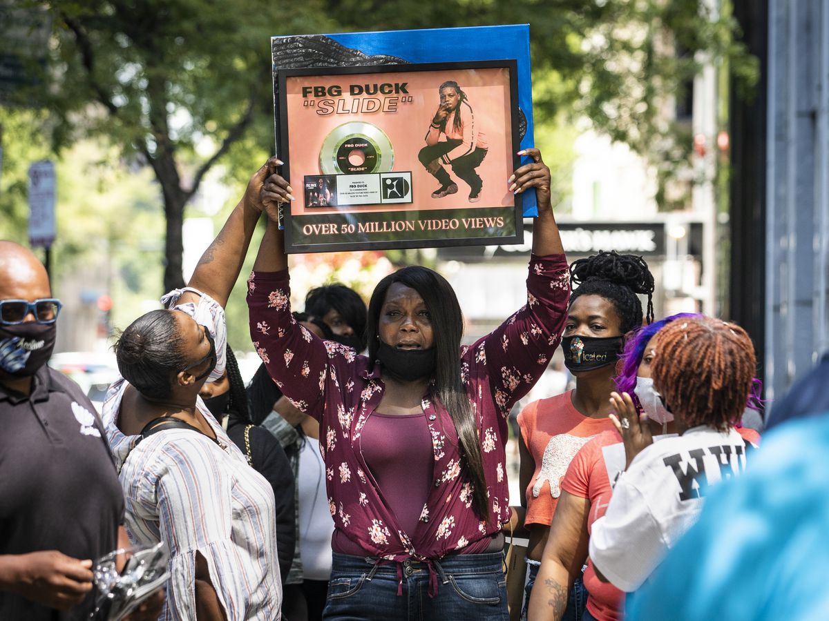 LaSheena&nbsp;Weekly, mother of Carlton Weekly, who performed as FBG Duck, holds a press conference with family and friends near the scene of her son’s fatal shooting in the first block of East Oak Street in the Gold Coast, Friday, Aug. 7, 2020. 