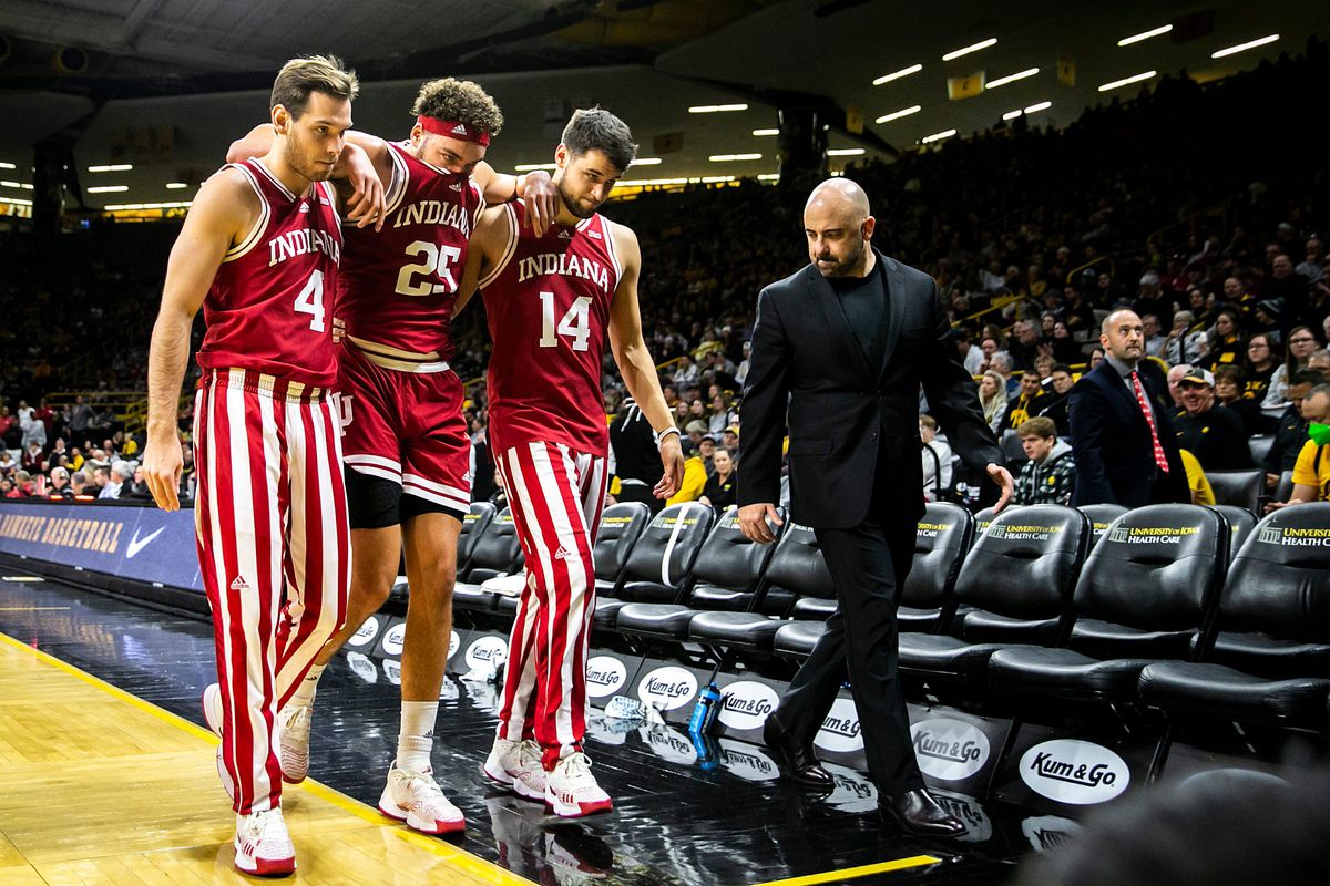 Indiana forward Race Thompson gets helped off the floor by teammates Michael Shipp, left, and Nathan Childress after getting injured as Clif Marshall, director of athletic performance, right, looks on during a NCAA Big Ten Conference men’s basketball game against Iowa, Thursday, Jan. 5, 2023, at Carver-Hawkeye Arena in Iowa City, Iowa.