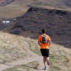 A trail runner makes his way across the Bonneville Shoreline Trail in Salt Lake City on Thursday, Feb. 12, 2015. All of the lower elevation snowpack is gone.
