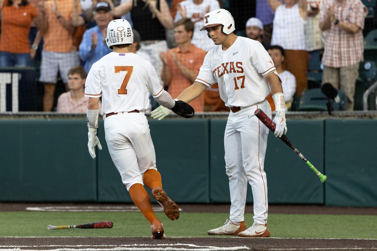 Texas Longhorns outfielder Douglas Hodo (7) is congratulated at home plate by Texas Longhorns infielder Ivan Melendez (17) during the game between Texas Longhorns and Oklahoma State Cowboys on April 29, 2022, at UFCU Disch-Falk Field in Austin, TX.