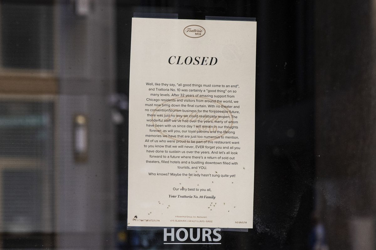 A sign in a window displaying a message that the restaurant is closed.
