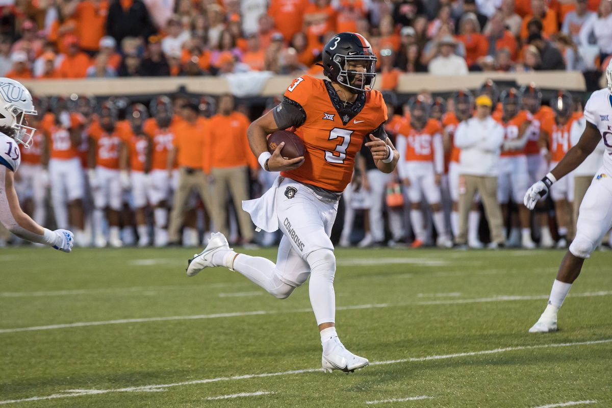 Oklahoma State Cowboys quarterback Spencer Sanders (3) runs towards the end zone for touchdown during the first quarter against the Kansas Jayhawks at Boone Pickens Stadium.