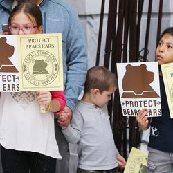 Mya, Jaxon and Lilly Jansen holds signs promoting the creation of a Bears Ears National Monument during a rally at the Capitol in Salt Lake City on Wednesday, May 18, 2016.