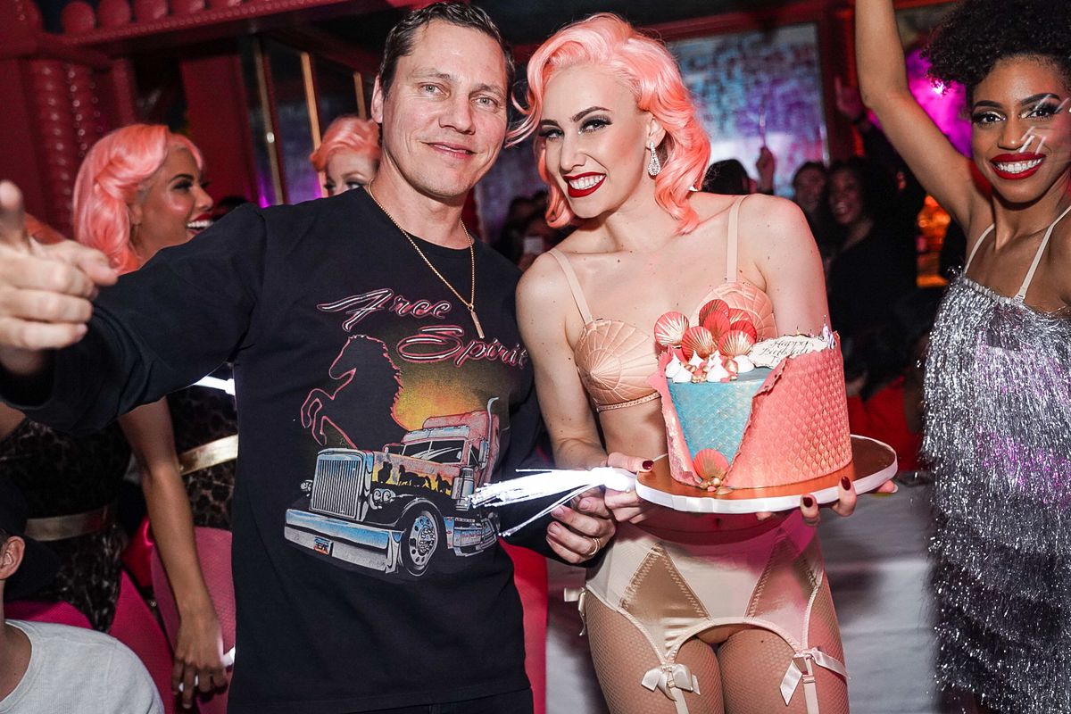 A man and a woman holding a cake