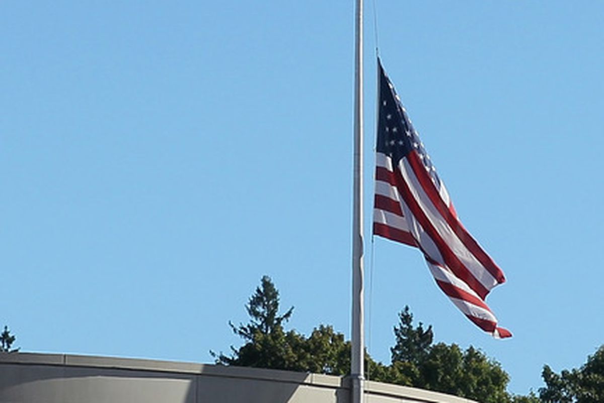 The flag is raised to  half staff in honor of the 9/11 attacks during a game at Boston College