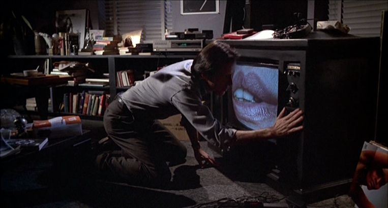 James Woods caresses a television with lips in Videodrome