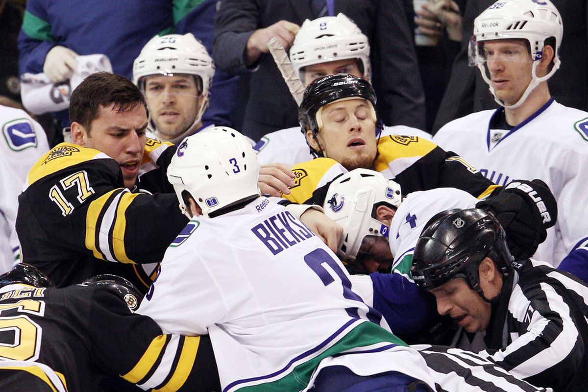 BOSTON, MA - JANUARY 07:  Milan Lucic #17 of the Boston Bruins fights with Kevin Bieksa #3 of the Vancouver Canucks in the first period on January 7, 2012 at TD Garden in Boston, Massachusetts.  (Photo by Elsa/Getty Images)