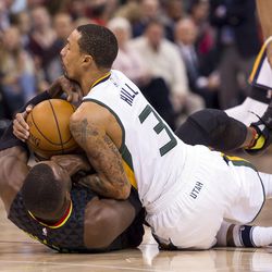 Utah guard George Hill (3) fights for possession of the ball with Atlanta forward Paul Millsap (4) during an NBA basketball game at Vivint Smart Home Arena in Salt Lake City on Friday, Nov. 25, 2016.