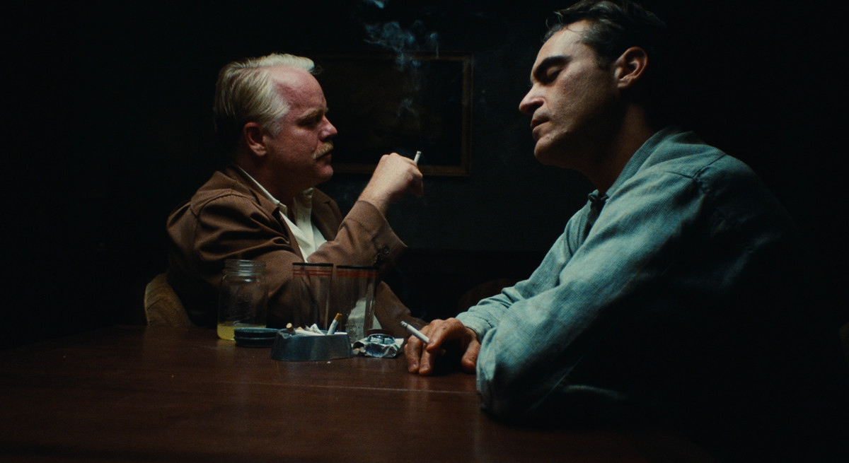 Lancaster Dodd (Philip Seymour Hoffman) processes Freddie Quell (Joaquin Phoenix) while smoking a cigarette in a key scene from The Master