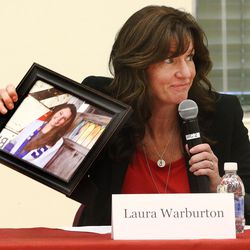 Laura Warburton holds a photo of her daughter Hannah, who committed suicide, as she joins Sen. Orrin Hatch and others at a suicide-prevention conference at East High School  in Salt Lake City on Friday, Dec. 16, 2016.