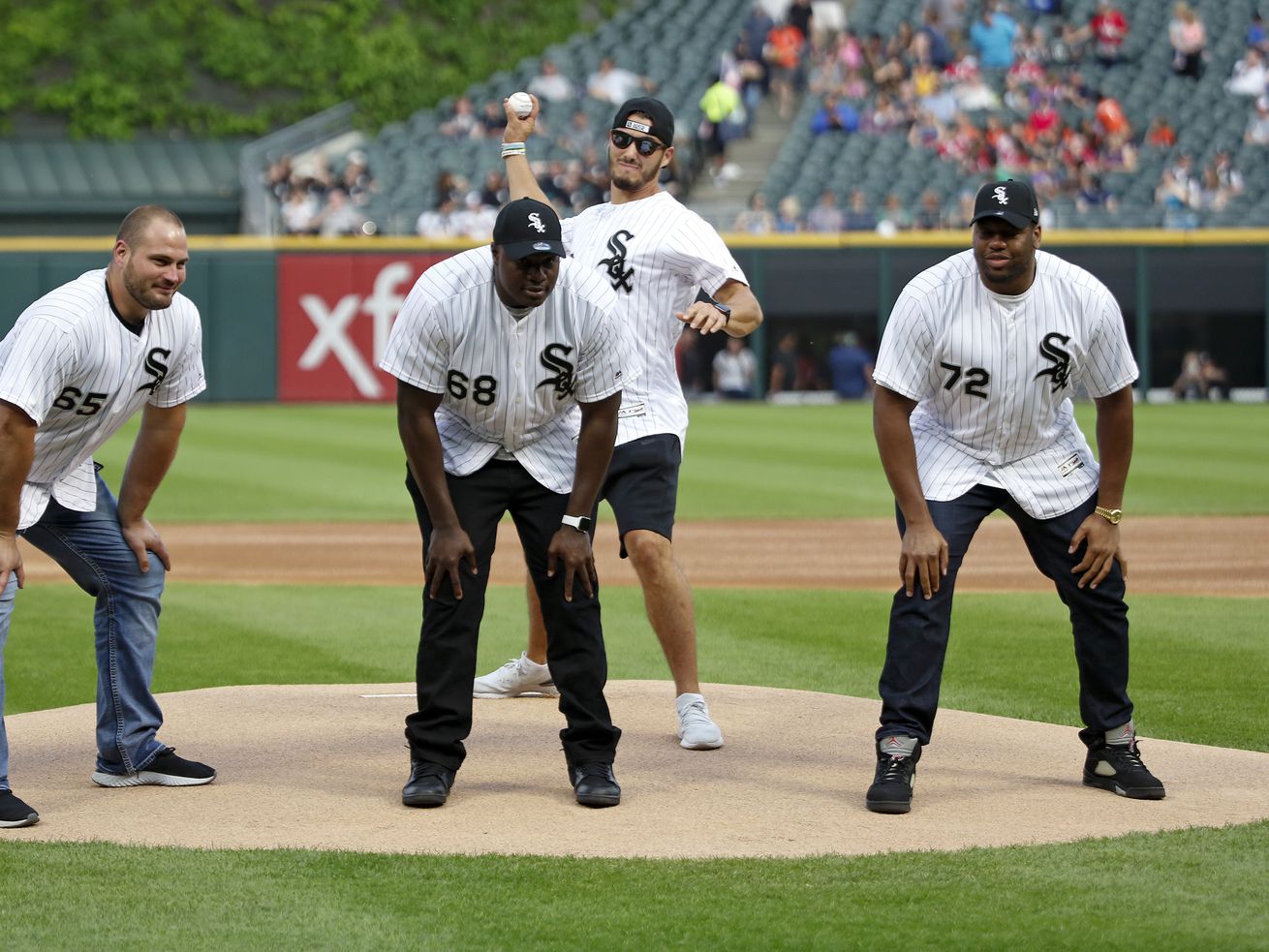 Bears quarterback Mitch Trubisky throws the ceremonial first pitch behind teammates Cody Whitehair, James Daniels, and Charles Leno Jr., before the game against the Cleveland Indians at Guaranteed Rate Field on Friday.
