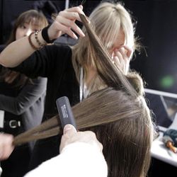 A model has her hair styled backstage before the fall 2010 collection of BCBGMAXAZRIA is presented during Mercedes-Benz Fashion Week, in New York,  Thursday, Feb. 11, 2010. 