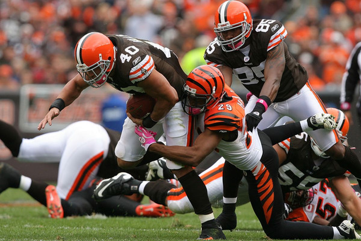 CLEVELAND - OCTOBER 03:  Running back Peyton Hillis #40 of the Cleveland Browns is hit by cornerback Leon Hall #29 of the Cincinnati Bengals at Cleveland Browns Stadium on October 3 2010 in Cleveland Ohio.  (Photo by Matt Sullivan/Getty Images)