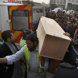 Pakistani rescue workers and volunteers unload a casket carrying the body of a plane crash victim at a local hospital in Islamabad, Pakistan, Thursday, Dec. 8, 2016. Pakistani military helicopters ferried the remains of plane crash victims to the capital, Islamabad, as aviation authorities said they opened a probe into the crash that killed 47 passengers and crew the day before in the country's northwest. 