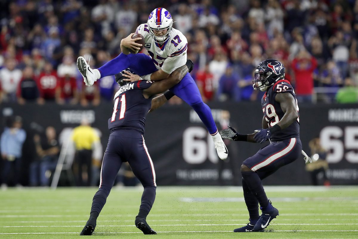 Quarterback Josh Allen of the Buffalo Bills leaps over linebacker Zach Cunningham of the Houston Texans during the AFC Wild Card Playoff game at NRG Stadium on January 04, 2020 in Houston, Texas.