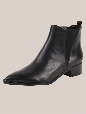 A pair of pointed toe black Marc Fisher ankle boots.