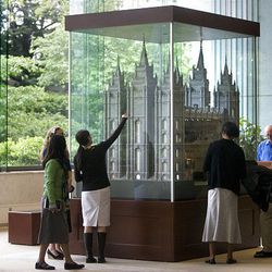 People view a scaled architectural model of the LDS Salt Lake Temple that was placed on display Friday in the South Visitors' Center at Temple Square in Salt Lake City.