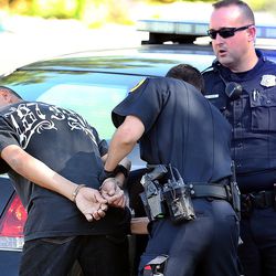 Salt Lake police officers arrest a man at 800 West and North Temple following a shooting at 757 W. 200 North in Salt Lake City on Tuesday, Aug. 15, 2017.