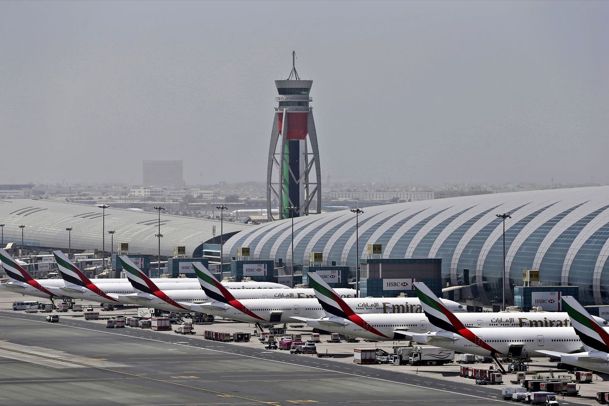 In this April 20, 2017, file photo, Emirates planes are parked at the Dubai International Airport in Dubai, United Arab Emirates. The Middle East’s largest airline, Emirates, announced on Tuesday a net loss of $5.5 billion over the past year as revenue fell by more than 66% due to global travel restrictions sparked by the coronavirus pandemic.