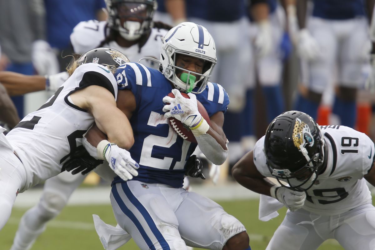 Jacksonville Jaguars safety Andrew Wingard (42) and wide receiver Collin Johnson (19) combine to bring down Indianapolis Colts running back Nyheim Hines (21) during the second half at TIAA Bank Field.