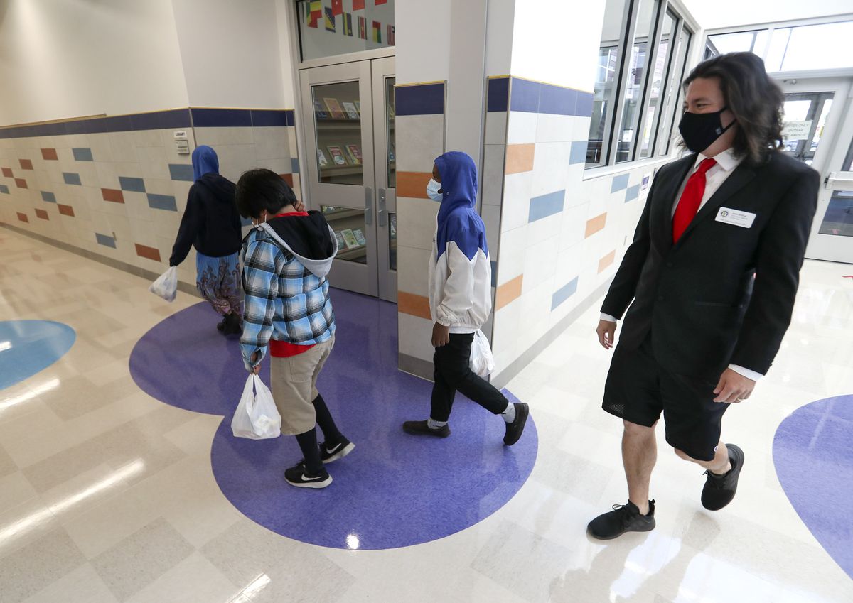 John Arthur, Utah’s Teacher of the Year, right, walks with a few of his sixth grade students after the grabbed their lunches at Meadowlark Elementary School in Salt Lake City on Thursday, Oct. 1, 2020.