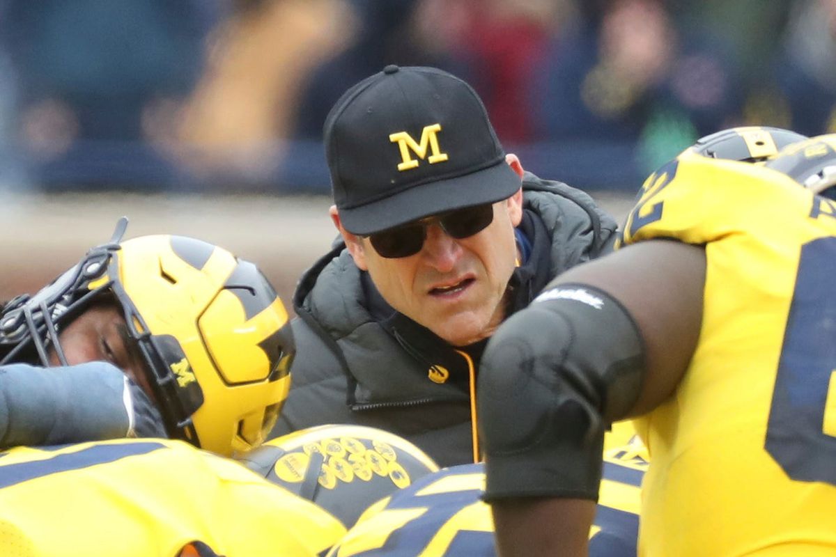 Jim Harbaugh listens to plays on the field during the Michigan spring game April 2, 2022 at Michigan Stadium in Ann Arbor.