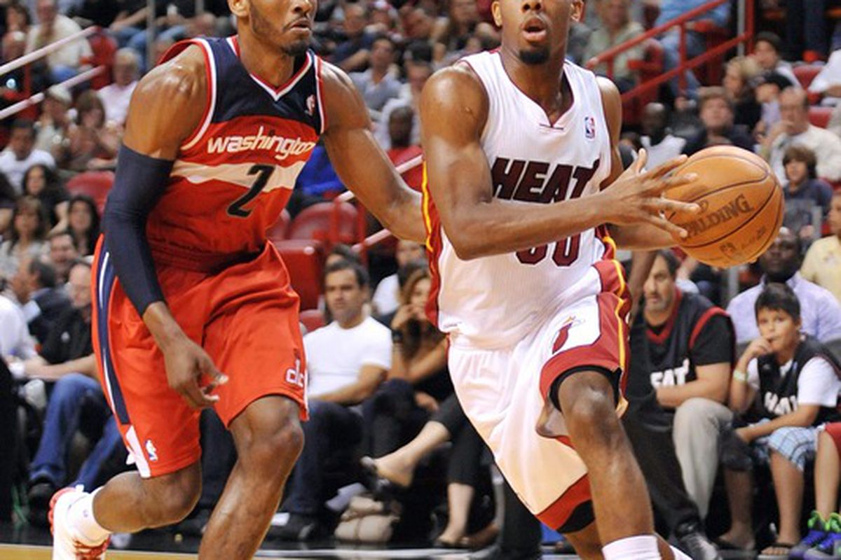April 21, 2012; Miami, FL, USA;Miami Heat point guard Norris Cole (30) drives to the basket as Washington Wizards point guard John Wall (2) defends during the second half at American Airlines Arena. Mandatory Credit: Steve Mitchell-US PRESSWIRE