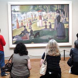 Visitors admire Georges Seurat's 1884 painting, "A Sunday on La Grande Jatte," at the Art Institute of Chicago.